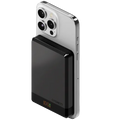 Smartphone with a black power bank attached on a light gray background