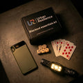 Blackout essentials kit with phone, flashlight, dice, and cards on a dark surface