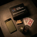 Blackout essentials kit with phone, dice, cards, and helmet on a dark surface